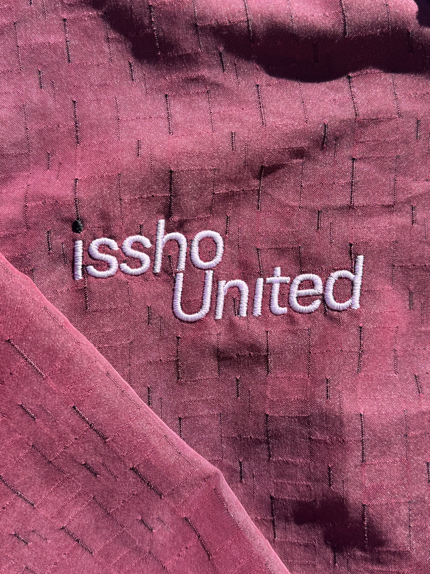 RED: Upcycled 'issho United' logo shirts