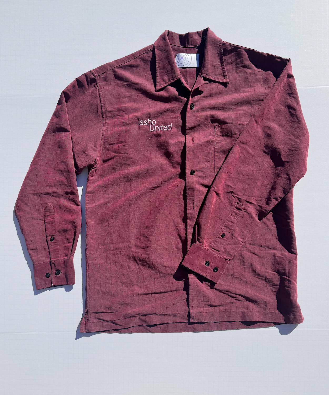 RED: Upcycled 'issho United' logo shirts